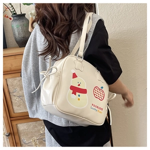 Detail of beige tote bag showing cute snowman print and side bow ribbon decoration