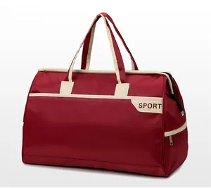 Detail view of burgundy travel bag with cream handles and side zipper pocket