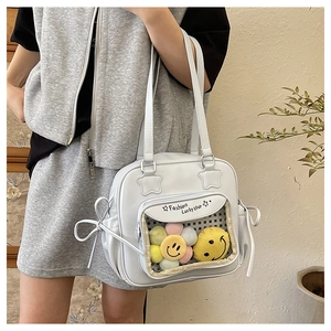 Detail of light blue Japanese ita bag with transparent PVC pocket and ribbon bows