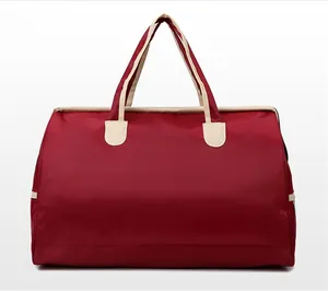 Back view of a large burgundy travel bag with beige handles and waterproof nylon fabric