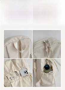Close-up of beige school backpack showing zippers, drawstring side pockets and handles