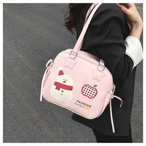 Detail of light pink tote bag featuring a cute snowman print and decorative side laces