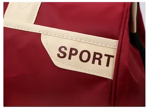 Close-up of red nylon sports travel bag with white sport lettering and stitch detail