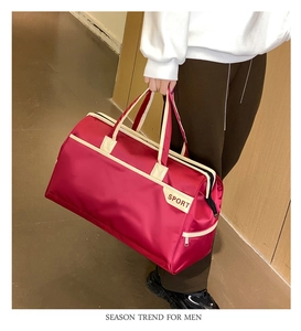Macro shot of large red sports travel bag with side zipper pocket and cream white trim
