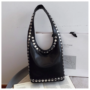 Detail of black leather Hobo bag featuring large silver metal studs and wide shoulder strap