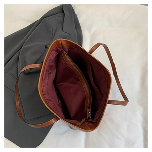 Top view showing the spacious interior compartments and red lining of the leather tote bag