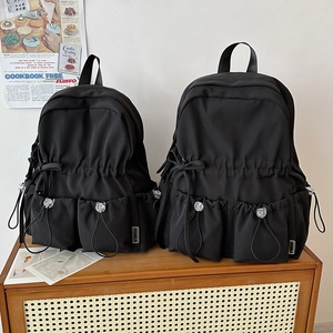 Black large capacity student backpack with cute ribbon design and waterproof nylon material