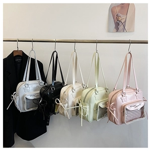 Detail of colorful tote bags with star patches, mesh pockets and bow ribbons