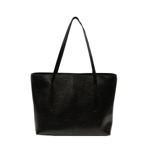 Vintage black tote bag in high-shine leather finish with a decorative side charm