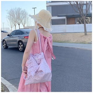 Floral purple tote bag with ruffle detail styled for a casual summer outdoor look