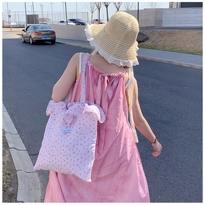 Detailed ruffled edges and floral cotton fabric on a large pink shoulder tote bag