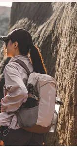 Detail of outdoor backpack with reinforced tear-resistant fabric and side mesh pocket