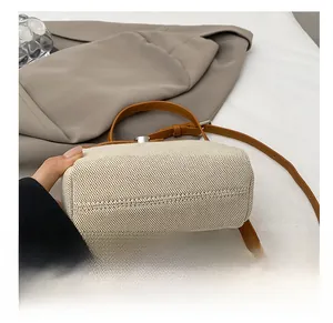 Detailed view of the woven texture and reinforced stitching on a large crossbody bag