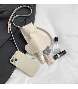 Internal view of beige elephant mini bag showing space for phone and cosmetics