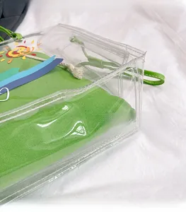 Close-up of transparent PVC beach bag with green canvas inner pouch and colorful sun print
