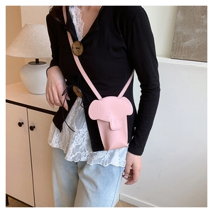 Detailed close-up of a pink elephant-shaped mini crossbody bag with a cute ear design