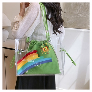 Detail of transparent PVC tote with green canvas drawstring inner bag and hand-drawn art