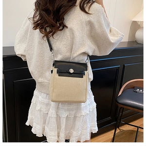 Canvas and leather patchwork crossbody bag shown on shoulder in a lifestyle setting