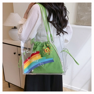 Detail of transparent PVC tote with green canvas drawstring inner pouch and rainbow print