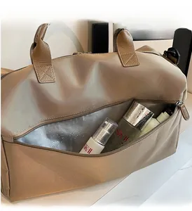 Detail of waterproof dry-wet separation pocket on champagne gold nylon fitness travel bag
