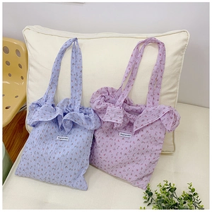 Close-up of floral seersucker tote bags in blue and purple with Magicpocket label