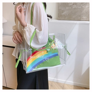 Detail showing transparent PVC beach tote with a green canvas inner bag and sunshine print
