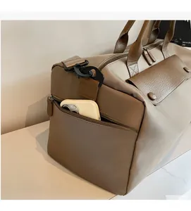 Detail of travel bag side zipper pocket showing ample storage space for a mobile phone