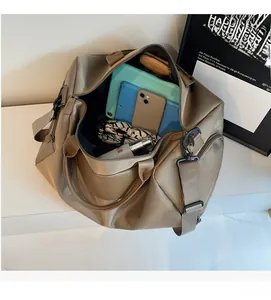 Macro view of khaki travel bag interior showing large capacity for electronics and cosmetics