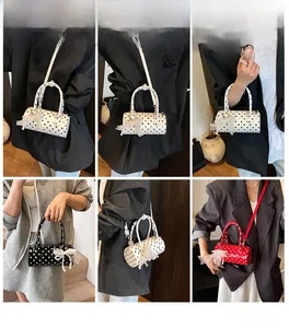 Detailed close-up of polka dot bucket bags with lace bows and pearl charms for women
