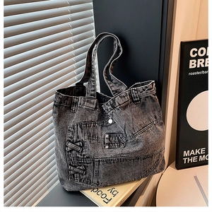Macro detail of dark grey denim tote bag showing jeans-style pockets and stitching