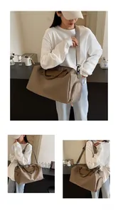 Close-up of large capacity oxford travel bag with adjustable strap shown in cross-body style