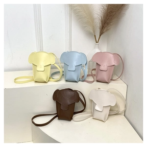 Mini elephant crossbody bags in five colors on a minimalist white display stand