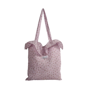 Pink floral tote bag with ruffled trim and spacious casual shoulder bag design