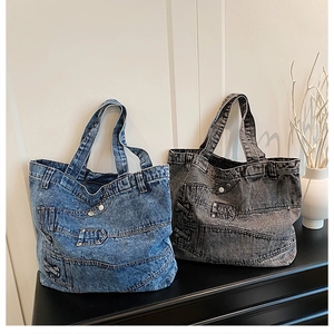 Detail of deconstructed denim tote bags with jean waist design in blue and grey