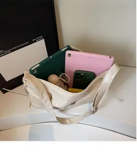 Spacious beige tote bag interior showing tablets, phone and umbrella storage