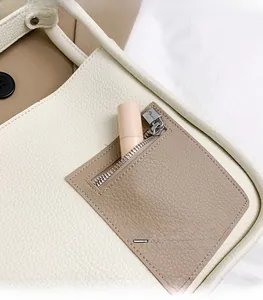 Detail of lychee pattern leather tote bag with functional exterior zipper pocket