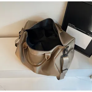 Interior view of large khaki fitness bag showing black lining and functional pockets