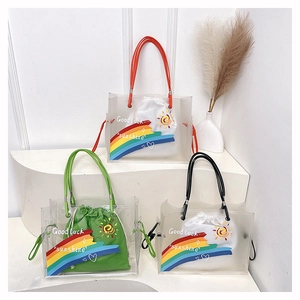 Detailed view of transparent PVC beach bags with rainbow prints and inner drawstring pouches