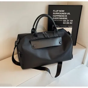 Close-up of black oxford fitness bag featuring premium leather accents and metal hooks
