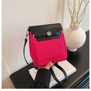 Detail of rose pink canvas and black leather crossbody bag with silver buckle and strap