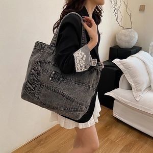 Retro wash denim tote bag for women featuring vintage pockets and lacing detail