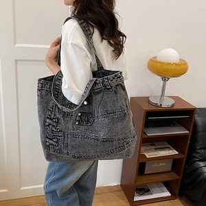 Vintage dark gray washed denim tote bag with multi-pockets and industrial style