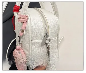 Detail of silver smooth zipper and white lychee pattern leather on a trendy handbag