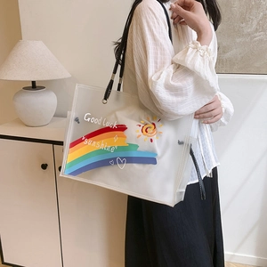 Transparent PVC tote bag with colorful rainbow print and black handles for daily casual use