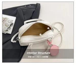 Top view of white pebble leather bag interior with main compartment and pink coin pouch