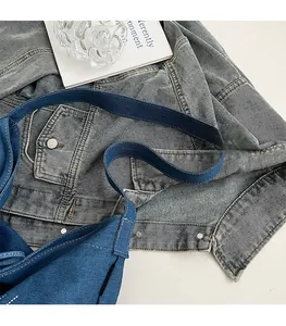 Detail of wide comfortable shoulder strap on deep blue denim tote bag for daily use