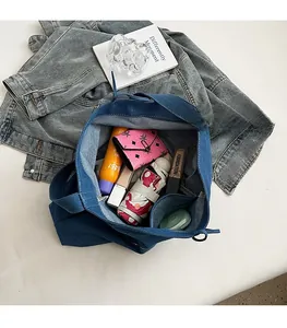 Detail of spacious denim tote bag interior showing large capacity for essentials