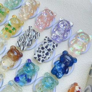 Detail of creative bear phone grips with glitter, gold foil, and marble textures