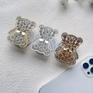 Detailed view of three luxury bear phone grips with sparkling rhinestones in three colors