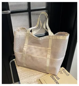 Detail of beige mesh tote bag showing breathable hollowed-out fabric and nylon handles